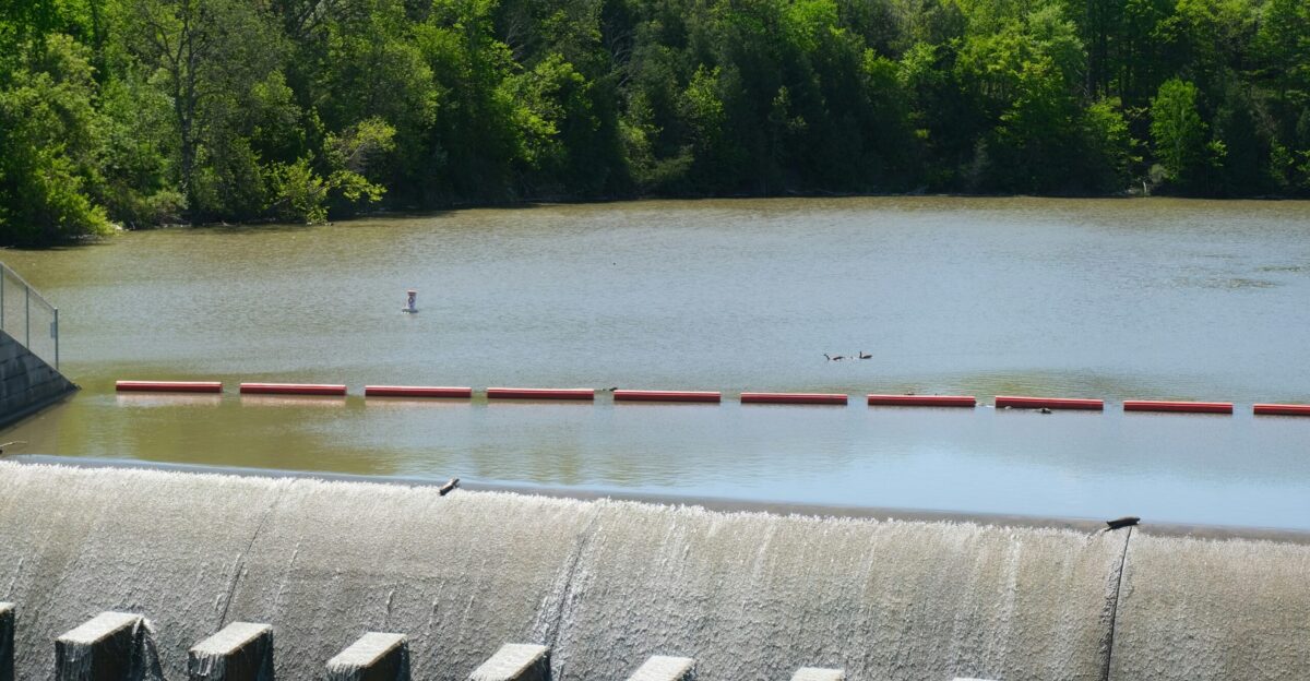 A concrete dam holds back a body of water