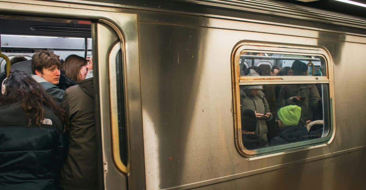 People are crowded on a subway train