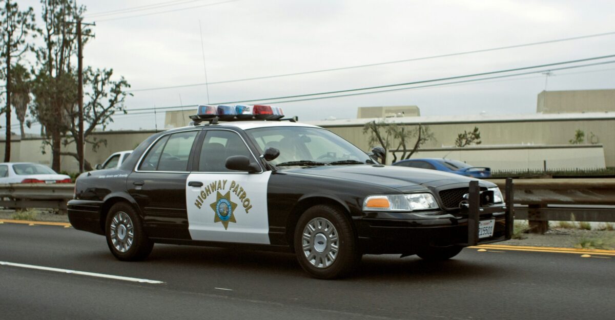 A california highway patrol car drives down the road