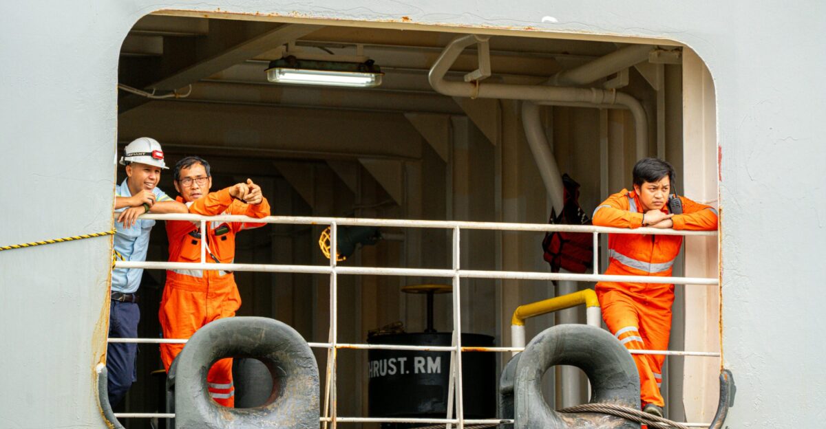 Ship crew members taking a break at the window
