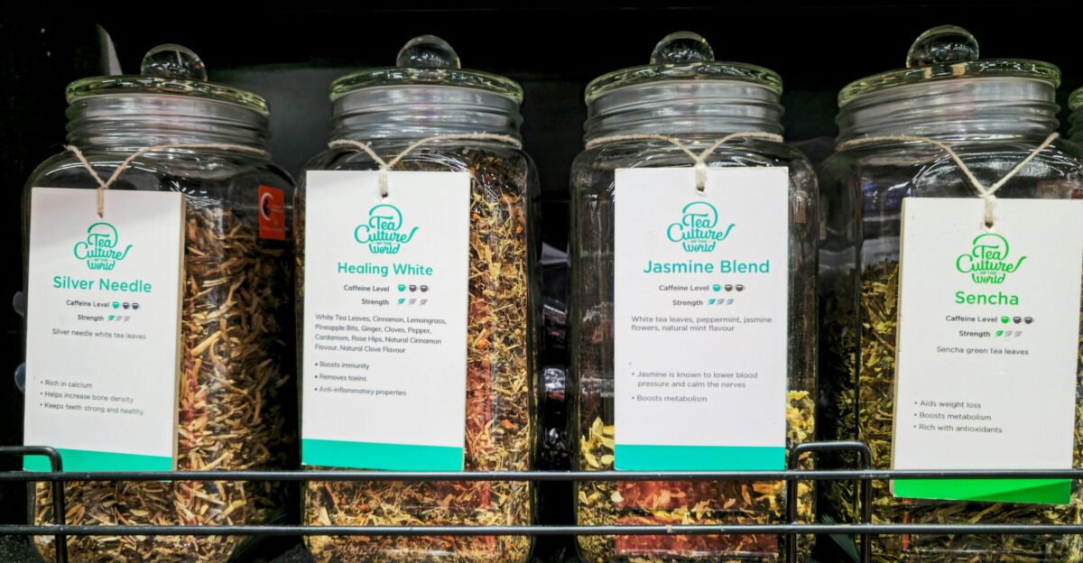 Four glass jars filled with dried herbs and spices