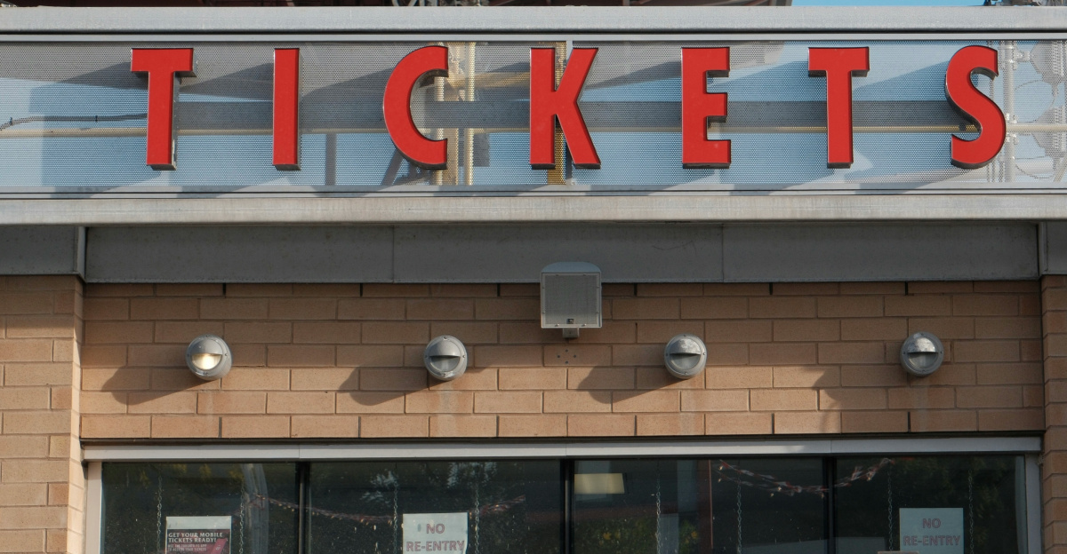 Red letters spell tickets above a building entrance.