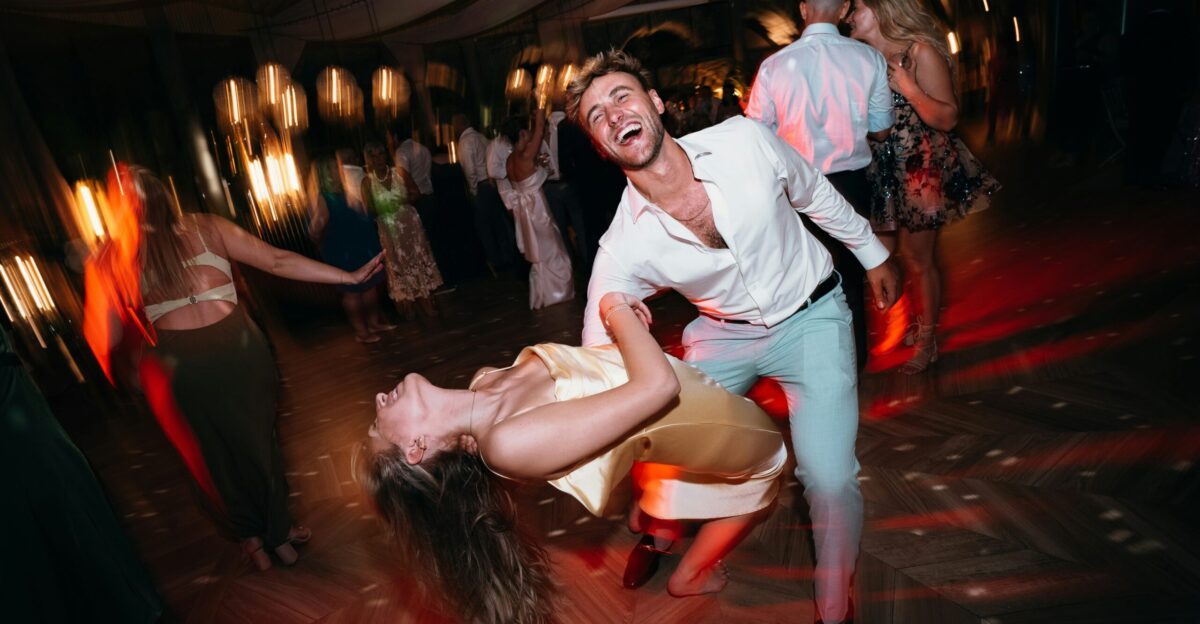 Couple dancing joyfully at a lively outdoor party