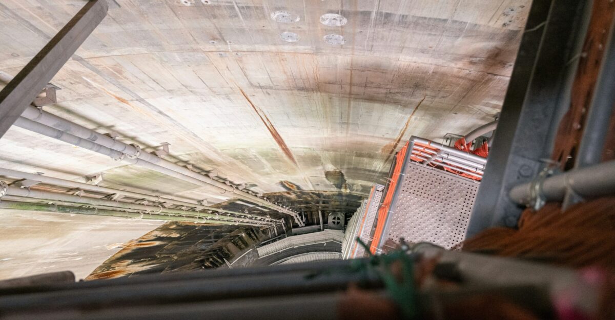 Looking down into a deep concrete tunnel construction