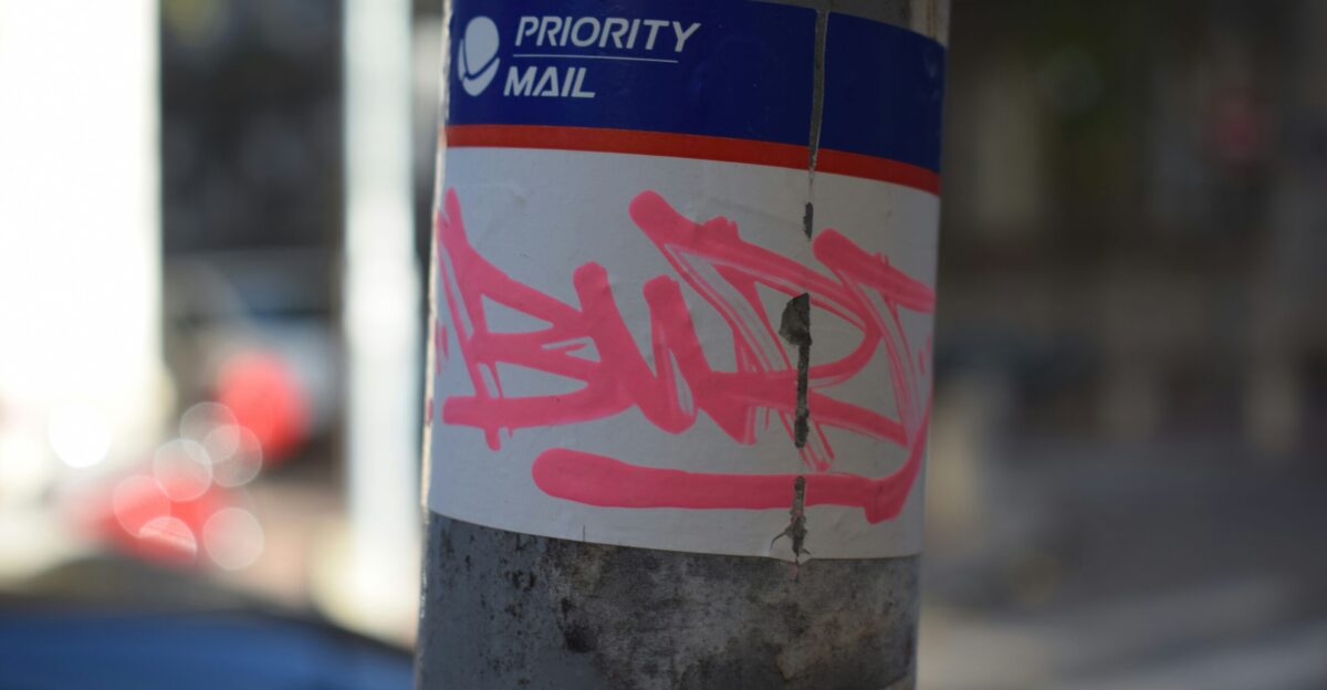 Graffiti on a usps priority mail sticker