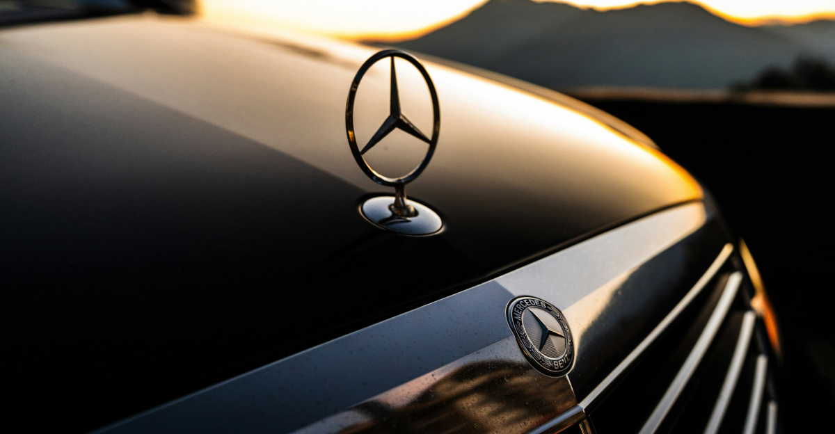 Close up of a mercedes-benz hood ornament at sunset