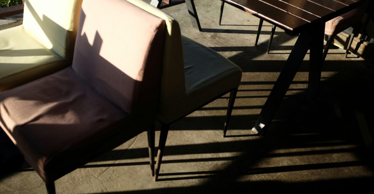 Chairs and table with strong sunlight shadows