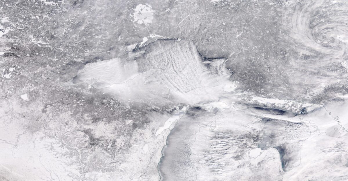 Desperately cold weather set record lows for much of the Midwest and Northern Plains of the United States as well as interior Canada in late January 2019 The culprit is a familiar one the polar vortex A large area of low pressure and extremely cold air usually swirls over the Arctic with strong counter-clockwise winds that trap the cold around the Pole But disturbances in the jet stream and the intrusion of warmer mid-latitude air masses can disturb this polar vortex and make it unstable sending Arctic air south into middle latitudes According to the National Weather Service and media reports the dipping polar vortex brought record low temperatures to a wide swath of the Midwest and Canada At least four cities reported the lowest temperatures ever on record Moline Illinois reached -33 F -36 1 C Rockford Illinois shivered at -31 F -35 C Cedar Rapids Iowa noted -30 F -34 4 C while north of Mather Wisconsin temperatures dipped to -43 F -41 7 C Wind chills as low as -60 or -65 were felt across much of Minnesota and a whopping -82 degree wind chill was reported in northern Manitoba and southern Nunavut Canada on January 28 On January 30 the Moderate Resolution Imaging Spectroradiometer MODIS on NASA s Aqua satellite acquired a true-color image as the frigid air blew across the Ontario and the Midwest Cloud streets and lake-effect snow stretch across the scene as frigid Arctic winds blew over the Great Lakes