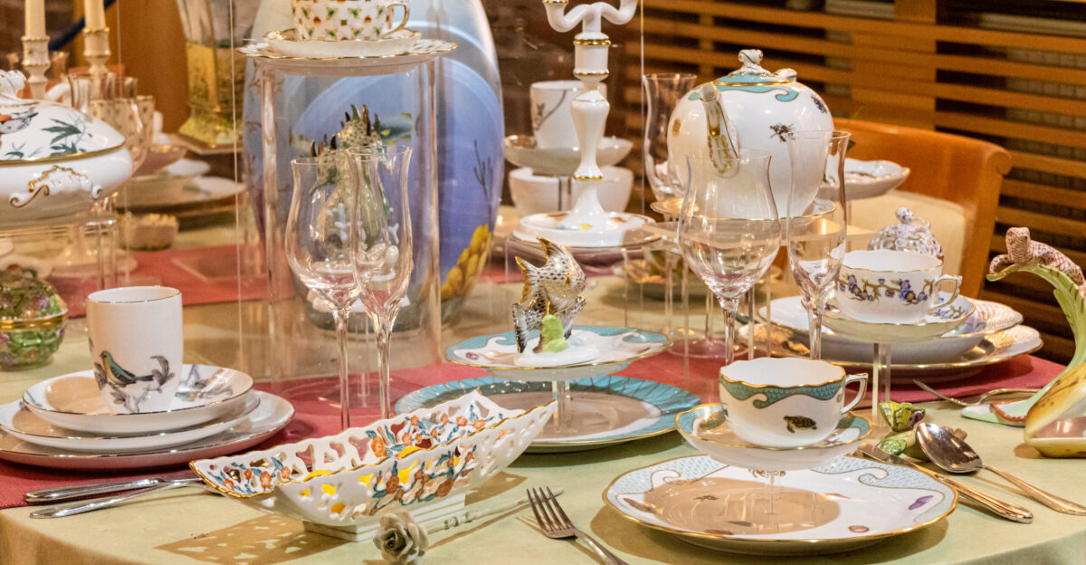 A table with porcelain products on display in the visitor center of the Herend Hungary porcelain factory