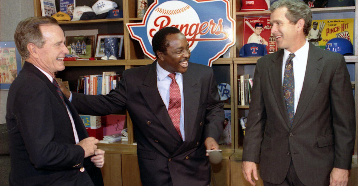 President George H W Bush with son George W Bush and baseball broadcaster Joe Morgan in the locker room at Texas Rangers v Milwaukee Brewers baseball game in Dallas TX