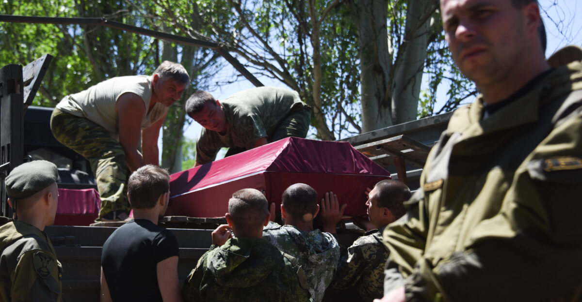 Pro-Russian rebels carry a coffin with a body of a fellow fighter killed in a battle for Marinka near Donetsk Eastern Ukraine 6 June 2015