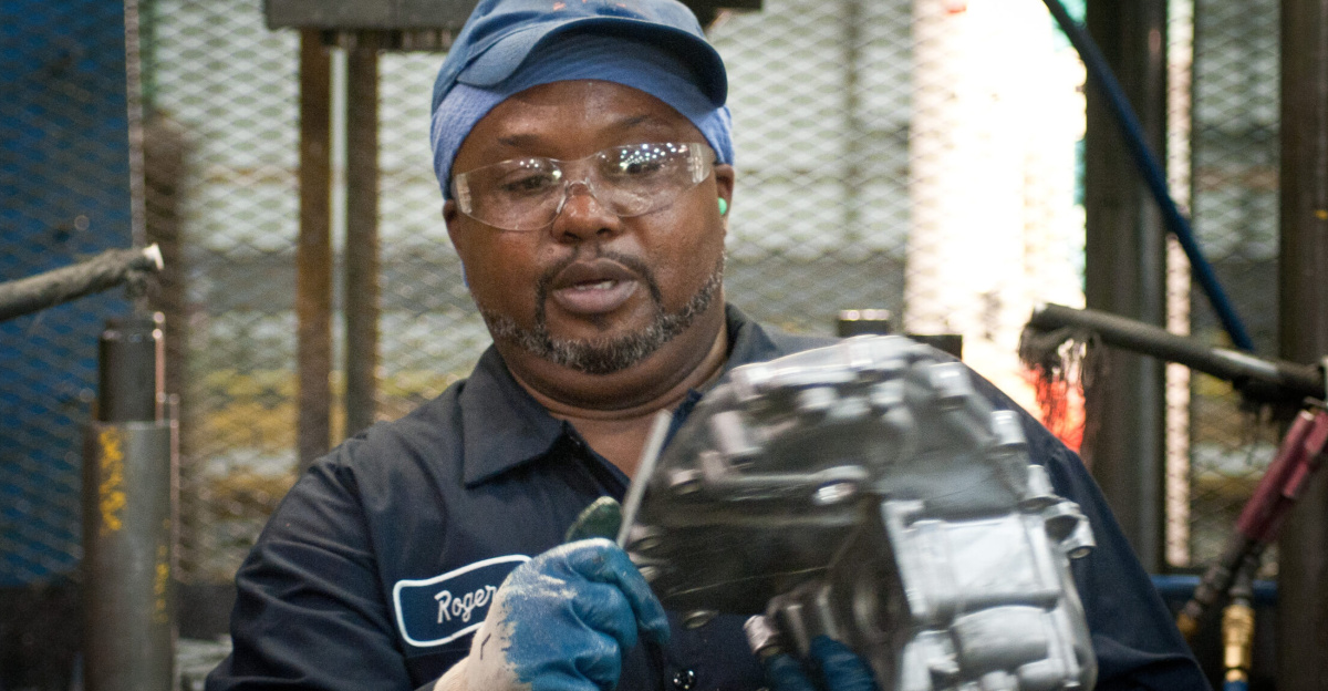 Trim Operator Roger Brown at Port City Group’s Port City Castings Corporation manufactures high-pressure aluminum die-castings, mostly for the automotive industry, in Muskegon, MI, facility on Wednesday July 20, 2011.  Port City Group boosted its employment by 12 percent over last year thanks to two Rural Business Guaranteed Loans totaling $9.6 million. In its 80,000 sq. ft. facility, machines that range from 800 – 1,600 tons, and cast A380 aluminum alloy products from melted ingots of aluminum, into automotive components of U.S.A. made vehicles.  The process features a variety of robotic presses; computer controlled machining; quality control facility; and complete measurement and testing laboratory. In 2009 banks were backing out of loans for PCG equipment purchase agreements. The U.S. Department of Agriculture (USDA) loan guarantee helped make the loan possible with its guarantee. PCG obtained the needed robotic and other equipment. This resulted in a stable workforce that has since grown. When asked about their USDA experience, Port City Group Sales Manager Laura LaGuire said, “It was great! They were very helpful. Everything that came up was handled smoothly, the money came in place when it was needed, and it was a very smooth transition.”  USDA Photo by Lance Cheung.