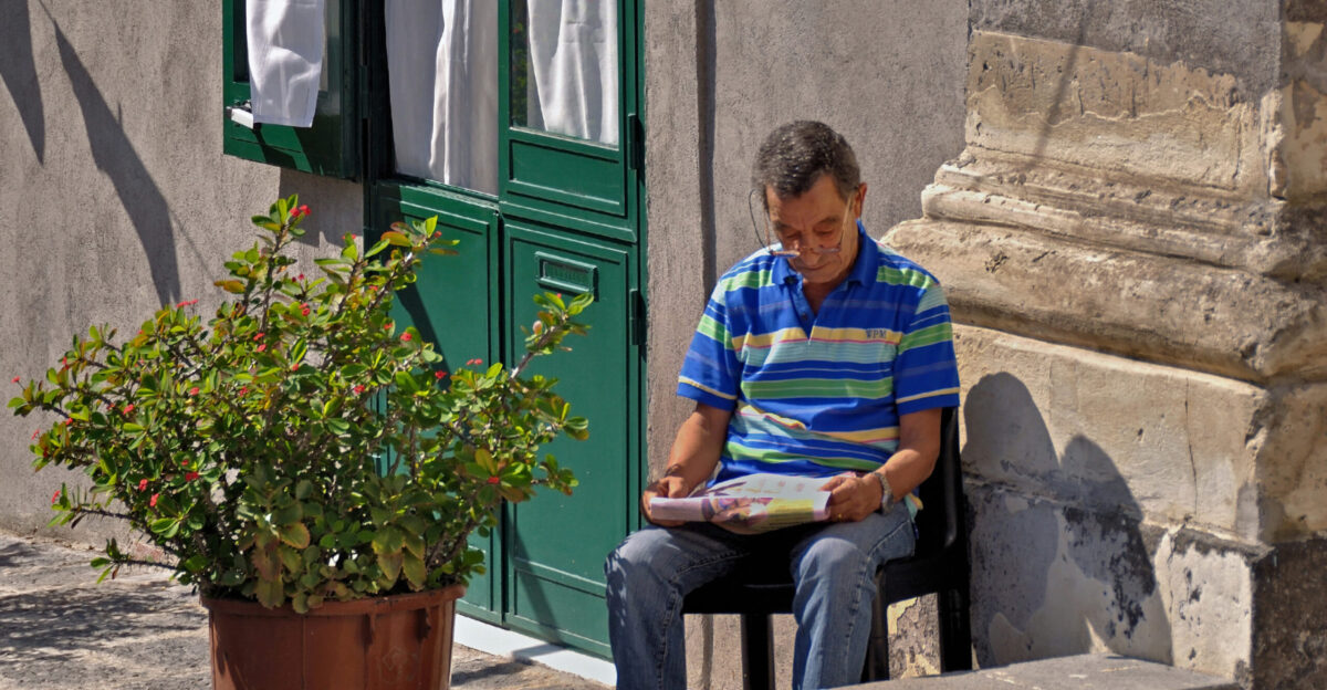 Reading a newspaper Catania Italy
