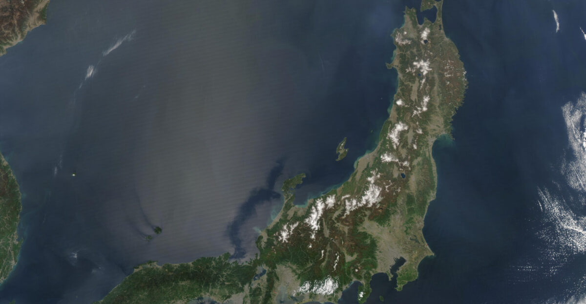 Satellite image of Japan in May 2003 The islands of Japan are shown clearly off the coast of North and South Korea China and Russia in this true-color image Running down through the islands are a string of mountains that make up part of the Pacific Ring of Fire The Ring of Fire is a zone of frequent earthquakes and volcanic eruptions that stretches in a series of arcs from New Zealand through Indonesia up through the Philippines Japan the Kuril Islands and Kamchatka Peninsula Russia across the Pacific Ocean via the Aleutian Islands and down the coast of the Americas Seventy-five percent of the world s volcanoes are in this ring making it the most volcanically-active region on the planet Also shown in this image are a number of fires which are marked with red dots A few fires were detected in Japan China and North Korea but the majority were detected in Russia s Primorskiy-Kray region This true-color Aqua MODIS image was acquired on May 1 2003