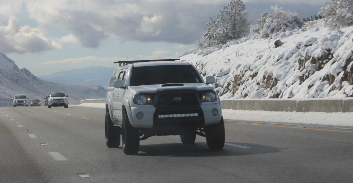 A white Second Gen Toyota Tacoma driving on a mountain in southern Utah