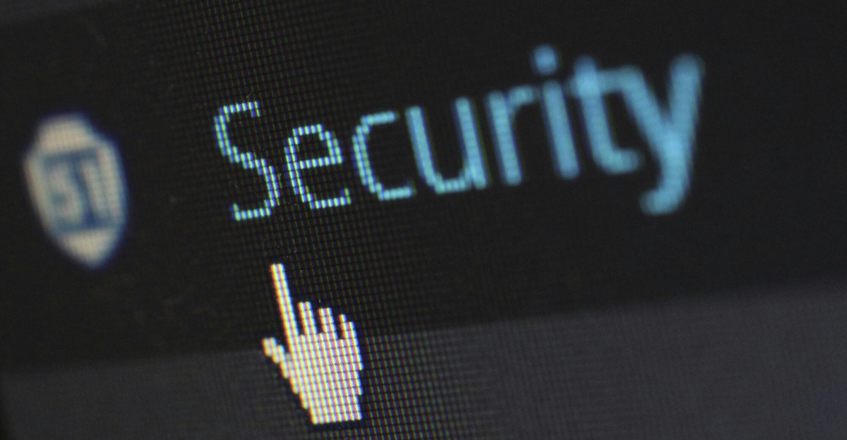 Close-up view of a mouse cursor over digital security text on display.