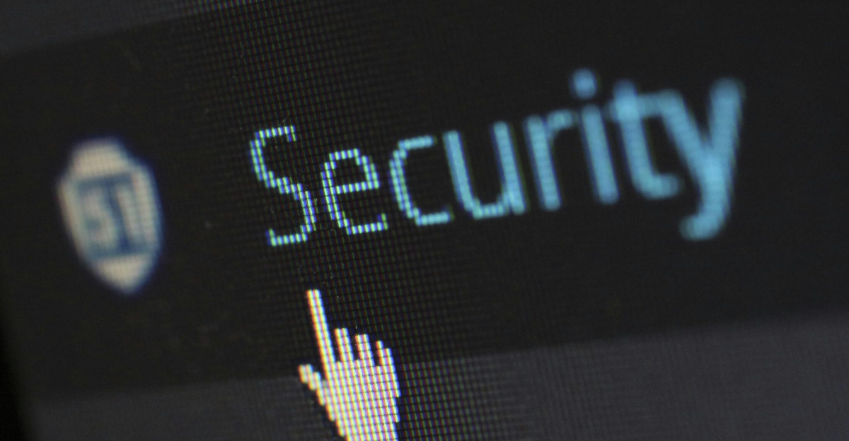 Close-up view of a mouse cursor over digital security text on display.