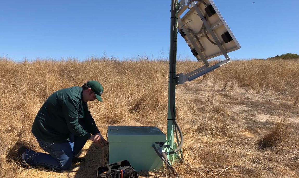 A USGS electronics technician performs maintenance on a ShakeAlert Earthquake Early Warning EEW sensor station located in the San Francisco Bay Area ShakeAlert station components include strong-motion accelerometers solar panel and battery power systems and communications telemetry equipment for communication with the wider ShakeAlert network