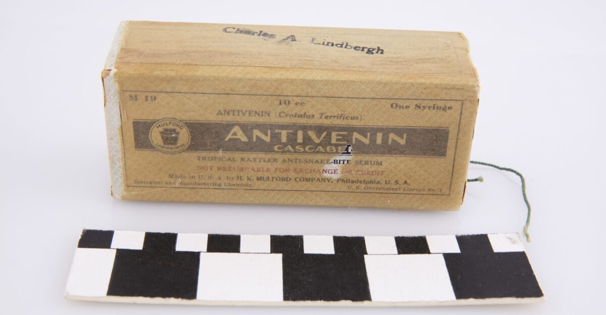 Cardboard box wrapped in wax paper containing one dose of an antivenom meant to treat snake bites Found with a collection of survival supplies in the Monocoupe 145 owned by Charles Lindbergh