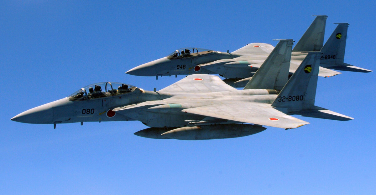 Two Japan Air Self Defense Force F-15 s fly alongside a U S Air Force KC-135 from the 909th Air Refueling Squadron Kadena Air Base during air refueling training July 30