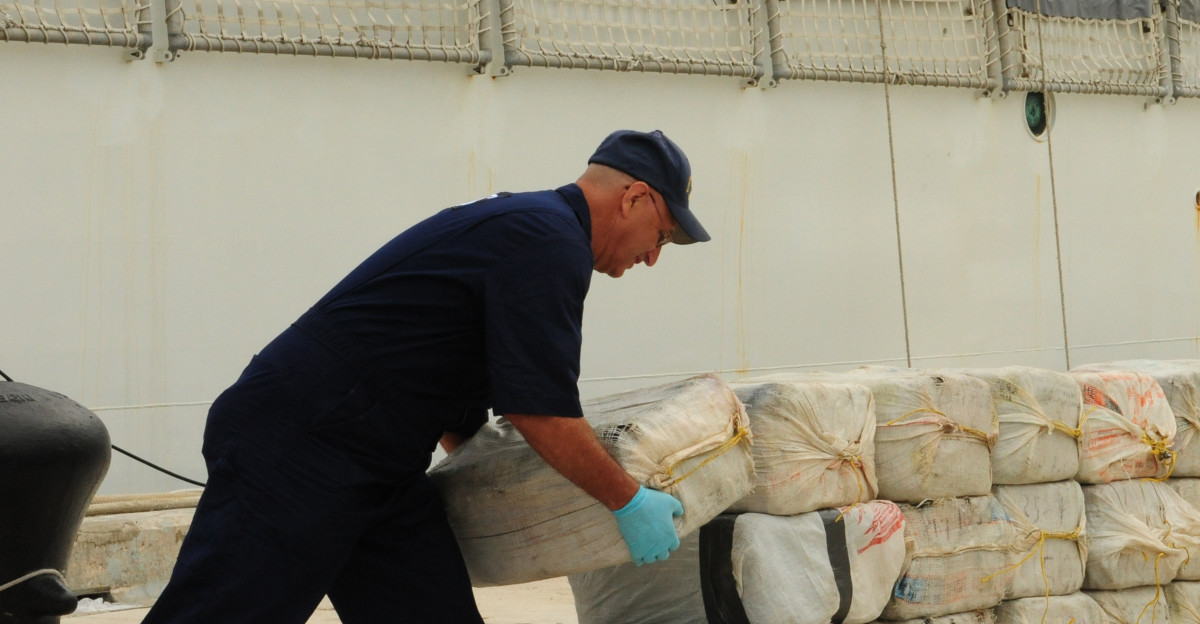 Petty Officer 1st Class Larry Berman a health service technician aboard the Coast Guard Cutter Tahoma stacks bales of cocaine on the pier at Base Support Unit Miami Aug 23 2010 Tahoma crewmembers offloaded 88 bales with an estimated street value of 87 million Unit U S Coast Guard Atlantic Area DVIDS Tags drugs Miami cocaine Coast Guard