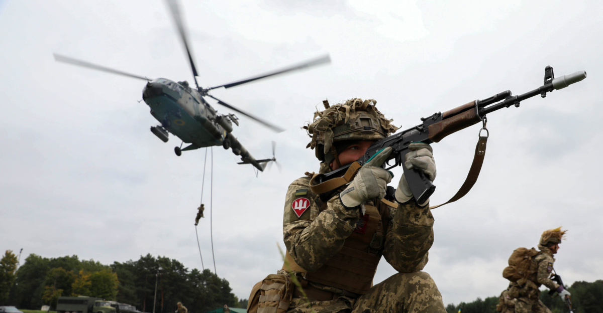 A Ukrainian Ground Forces soldier provides security during a fast rope from a Ukrainian Mi-8 helicopter as part of Rapid Trident 2021 at Combat Training Center-Yavoriv near Yavoriv, Ukraine, Sept. 21, 2021. Rapid Trident is 6,000 troops from 15 partner countries. During the exercise, joint jumps of Ukrainian and American paratroopers from a U.S. Army C-130 aircraft are planned. (U.S. Army photo by Spc. Preston Hammon)