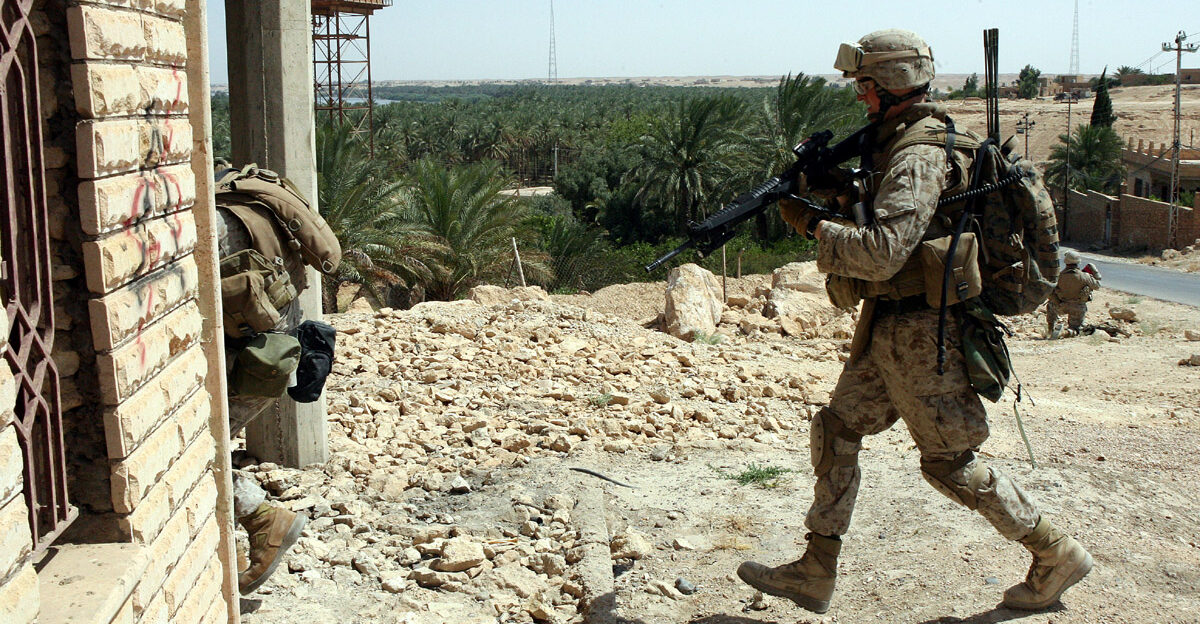 Marines from the Hawaii-based Lima Company 3rd Battalion 3rd Marine Regiment enter a house in Barwana Iraq during a search for weapons caches and explosives June 16 2006 Despite the stunning blow to Iraq s insurgency two weeks ago with the death of Al Qaeda in Iraq leader Abu Musab al Zarqawi Marines and Iraqi soldiers in this Al Anbar Province city are continuing the fight against terrorism by combating insurgent activity nearly daily But while the Marines and Iraqi soldiers patrol the worn streets lined with pock marks from improvised explosive devices homemade bombs that have bedeviled Coalition Forces the Marines are reminded that insurgents are still working behind the scenes and planning attacks in this city of 30 000 located on the Euphrates River northwest of Baghdad Still the Marines here say that even though it has been a long and grueling three months the insurgency is beginning to crumble as local residents are warming up to the Marines presence and the Iraqi Army is becoming a more solid and independent organization