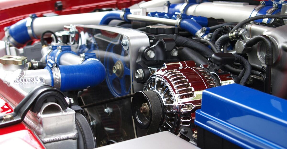 Detailed view of a clean modern car engine with vibrant colored components and sleek design