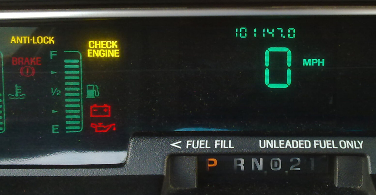 Digital dashboard cluster of a Mercury Grand Marquis. The cluster features three VFD displays (left third, middle third and right third). Varying colors are emitted through color filters.