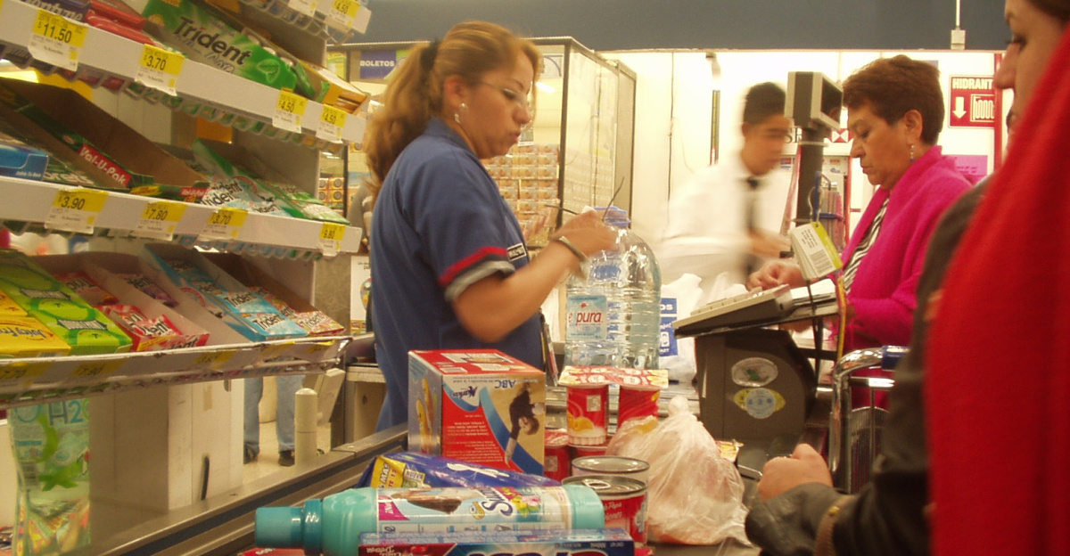 Cashier at Wal Mart - Plateros store located in Mexico City.
