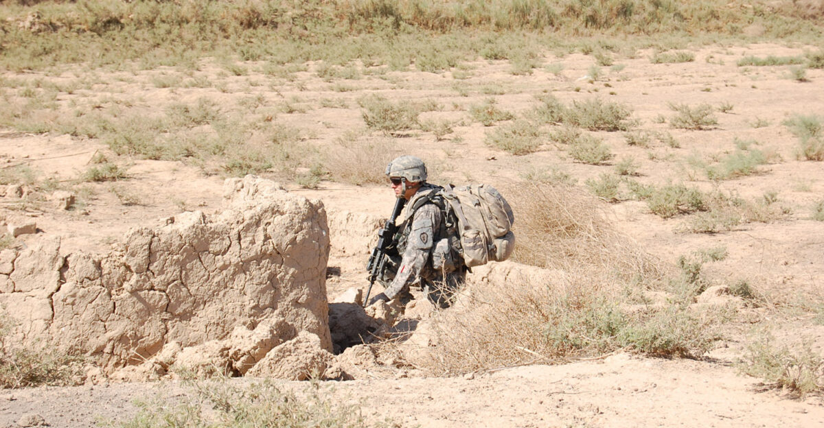 Pfc Albert Peralta a Long Beach Calif native pulls security during a security halt while conducting enemy weapons cache searches May 29 in the East Anbar province located northwest of Baghdad Peralta serves as a infantry rifleman with Company B 1st Battalion 27th Infantry Regiment Wolfhounds 2nd Stryker Brigade Combat Team Warrior 25th Infantry Division Multi-National Division - Baghdad U S Army photo Pfc John Ahn