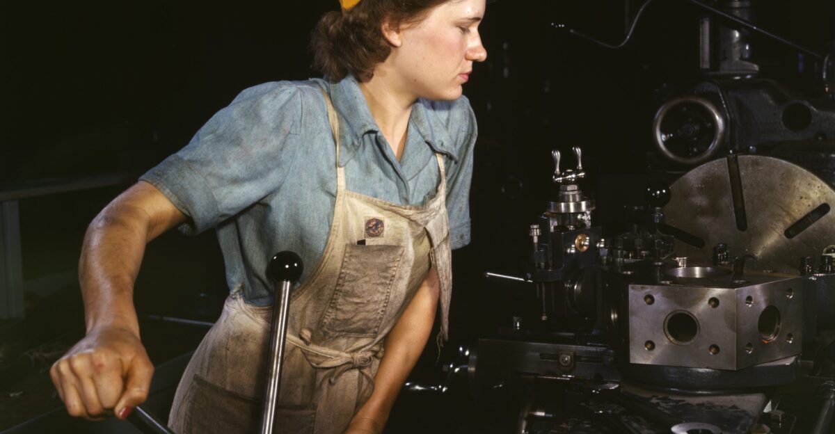 Turret lathe operator machining parts for transport planes at the Consolidated Aircraft Corporation plant Fort Worth Texas USA