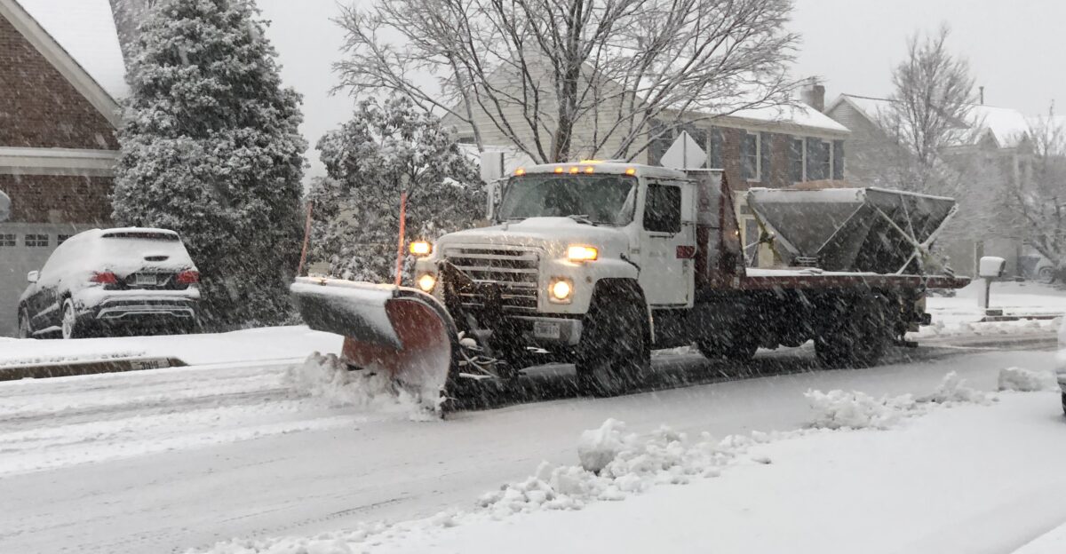 A truck plowing snow during a snowstorm along Kinross Circle at Scotsmore Way in the Chantilly Highlands section of Oak Hill Fairfax County Virginia