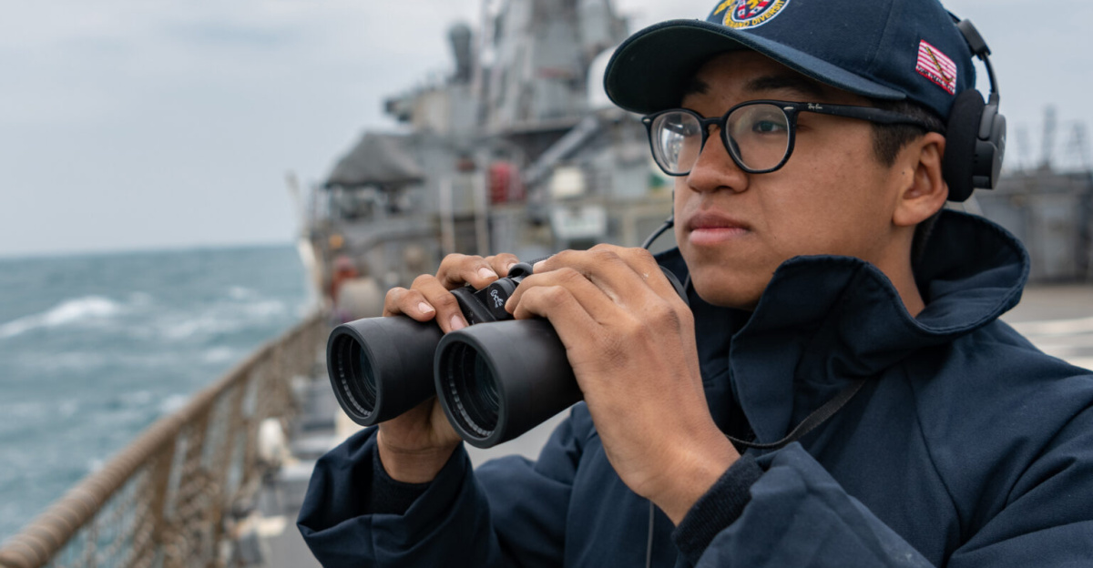 TAIWAN STRAIT (April 23, 2020) Seaman Xi Chan stands lookout on the flight deck as the Arleigh Burke-class guided-missile destroyer USS Barry (DDG 52) transits the Taiwan Strait during routine underway operations. Barry is forward-deployed to the U.S. 7th Fleet area of operations in support of security and stability in the Indo-Pacific region. (U.S. Navy photo by Ensign Samuel Hardgrove/Released)200423-N-NK931-004