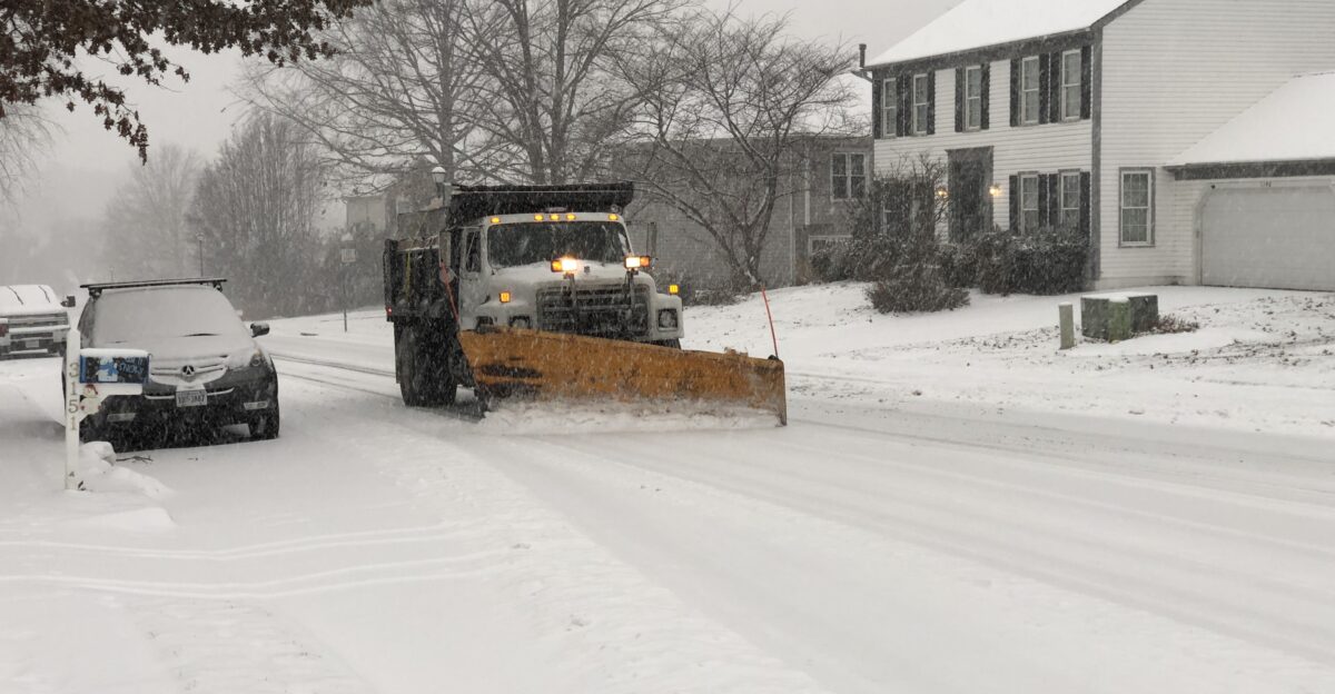 A truck plowing snow during a snowstorm along Kinross Circle in the Chantilly Highlands section of Oak Hill Fairfax County Virginia