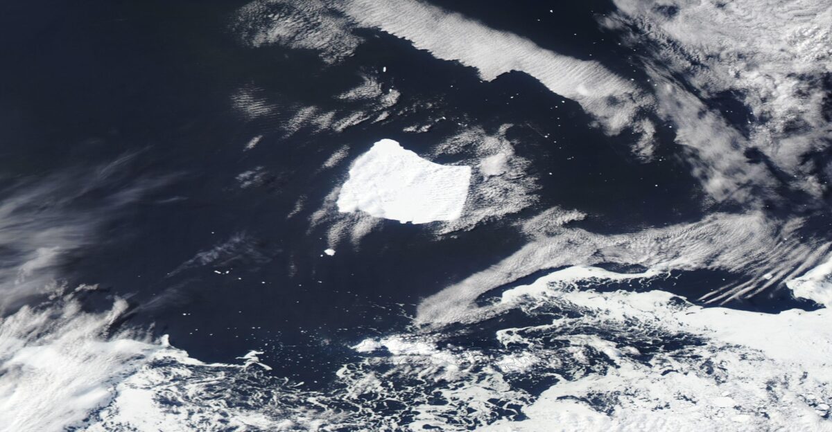 Six months after Iceberg A23a became trapped over a column of whirling water it continues to spin north of South Orkney Island The Moderate Resolution Imaging Spectroradiometer MODIS on NASA s Aqua satellite capture a true-color image of the unfortunate iceberg on October 16 2024 Iceberg A23a calved from the Filchner-Ronne Ice Shelf which is located on the northwestern side of Antarctica in a mass-calving event in 1986 While most of the other bergs calved at the same time floated away the massive A23a grounded in the Weddell Sea off the coast of West Antarctica almost immediately It was stuck in that location for fourteen years until it began to float freely in 2020 By March 2023 A23a was riding the currents on a typical path apparently heading towards the Southern Ocean via iceberg alley where it would eventually melt Iceberg Alley is the term used for a part of the Circumpolar Current that heads north of South Orkney Island This strong current frequently captures icebergs which float along until they reach relatively warm waters and begin to melt However the sea floor under the Current affects the flowing water above it In particular a small seafloor lump called the Pirie Bank interacts with the flowing current to cause it to spin This can create a column of rotating water from near the seafloor all the way up to the surface Known as a Taylor Column the spinning water can be quite long-lived and things captured in the column may stay there for days or months or more According to an August 2024 story published by the BBC a scientific buoy placed in a different Taylor Column near the Pirie Band was trapped for at least four years A23a s spin-cycle over the Pirie Bank was first noticed in April 2024 It still continues to rotate about 15 degrees a day in nearly the same location How long this will continue is anyone s guess