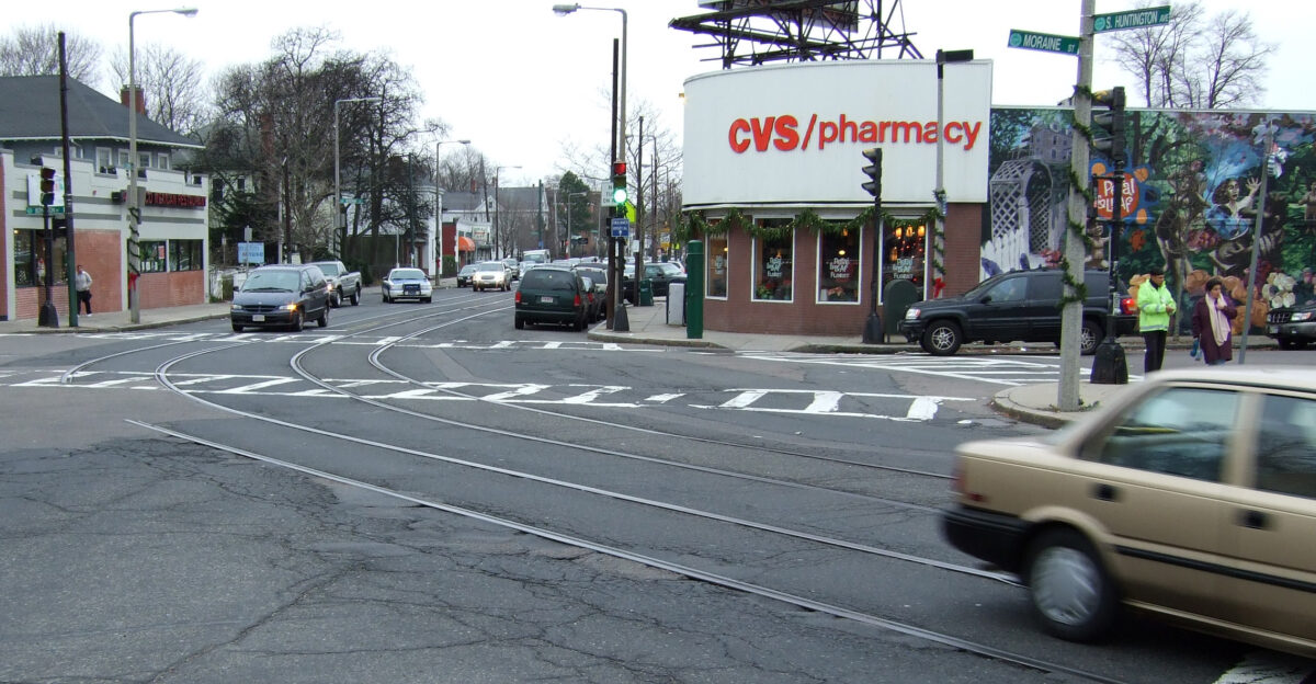 The intersection of Moraine Street and South Huntington Avenue clearly showing the abandoned streetcar tracks and catenary support poles that formerly served the Green Line E Branch Arborway Line