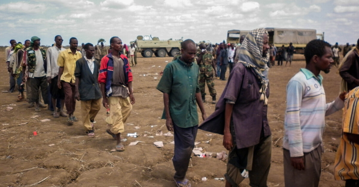 Members of the Al Qaeda-affiliated militant group Al Shabaab stand after giving themselves up to forces of the African Union Mission in Somalia AMISOM in Garsale approximately 10km from the town of Jowhar 80km north of the capital Mogadishu 22 September 2012 Over 200 militants disengaged following in-fighting between militants in the region in which 8 Al Shabaab were killed including 2 senior commanders The former fighters were peacefully taken into AMISOM s protection handing in over 80 weapons in the process in a further indication that the once-feared militant group is now divided and being defeated across Somalia Deputy Force Commander of AMISOM Operations Brigadier Michael Ondoga said a number of militants have contacted the AU force indicating their wish to cease fighting and that they their safety is assured if they give themselves up peacefully to AMISOM forces AU-UN IST PHOTO ABUKAR ALBADRI