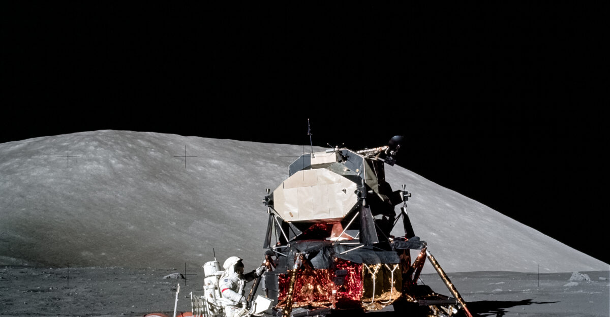AS17-147-22527 11 Dec 1972 - Astronaut Eugene A Cernan Apollo 17 mission commander makes a short checkout of the Lunar Roving Vehicle during the early part of the first Apollo 17 extravehicular activity EVA at the Taurus-Littrow landing site The Lunar Module is in the background This photograph was taken by scientist-astronaut Harrison H Schmitt lunar module pilot