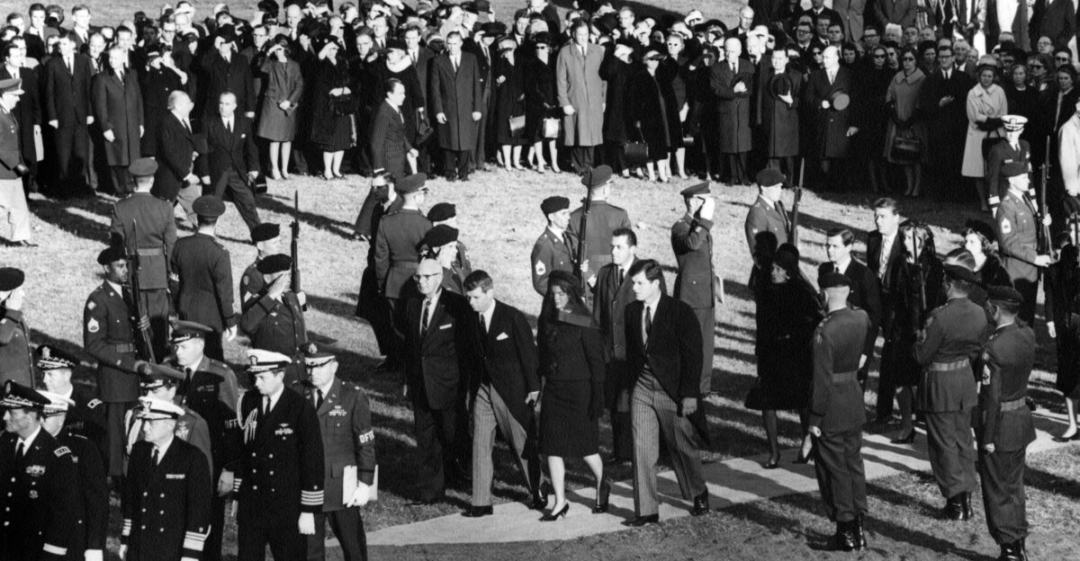Members of the Kennedy family and others walk to the gravesite of President John F Kennedy upon arrival at Arlington National Cemetery for graveside services in the state funeral of President Kennedy Walking in procession Attorney General Robert F Kennedy Jacqueline Kennedy Senator Edward M Kennedy Massachusetts Rose Fitzgerald Kennedy Steve Smith Peter Lawford Jean Kennedy Smith Eunice Kennedy Shriver Patricia Kennedy Lawford Superintendent of Arlington National Cemetery John C Metzler Chief of Staff of the United States Army General Earle G Wheeler Commandant of the United States Marine Corps General David M Shoup Commandant of the United States Coast Guard Admiral Edwin J Roland Military Aide to President Kennedy General Chester V Clifton Air Force Aide to President Kennedy Brigadier General Godfrey T McHugh Naval Aide to President Kennedy Captain Tazewell Shepard White House Secret Service agent Clint Hill Officials and dignitaries observe including Senator Kenneth B Keating New York Senator Daniel Inouye Hawaii Arlington Virginia