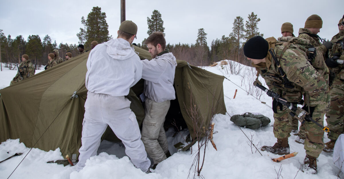From left Lance Cpl Samuel Melby and 1st Lt Oskar Gr berg both assigned to 2nd Battalion Brigade Nord teach U S Soldiers with 1st Battalion 501st Parachute Infantry Regiment 2nd Infantry Brigade Combat Team Airborne 11th Airborne Division about Norwegian squad tents and their set up during Arctic Shock 24 in Skjold Norway March 21 2024 Arctic Shock is a combined U S and Norwegian exercise demonstrating interoperability with Arctic partners and capabilities in the harsh environment U S Army Photo by Sgt Avery Cunningham