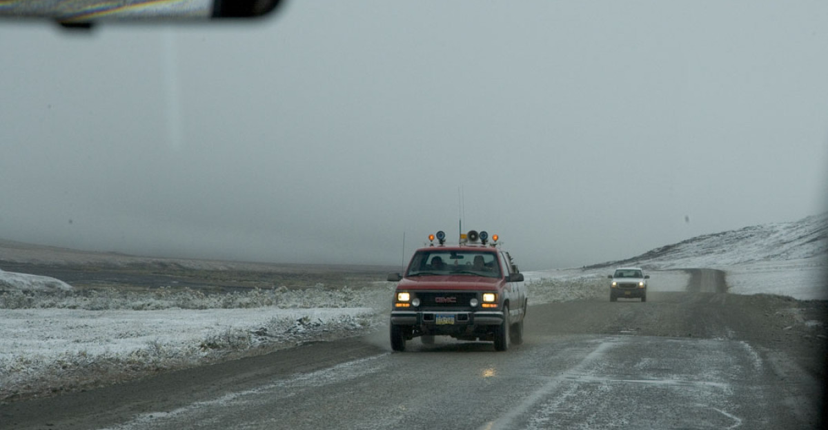 August snow storm on Dalton Highway 1 On-coming traffic on Dalton Highway during an August snowstorm photographed through the windshield FWS keywords Human impacts Tundra Terrestrial ecosystems Snow Automobiles Roads Alaska KANUTI NATIONAL WILDLIFE REFUGE Source Alaska Region Library