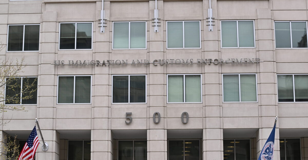 Immigration and Customs Enforcement building with flags and name above the entrance 500 12th Street SW Washington DC 20536