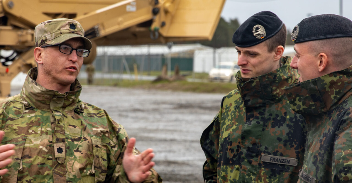 Bundeswehr and U.S. Soldiers discuss tank capabilities at the 7th Army Training Command's (7ATC) Grafenwoehr Training Area, Germany on April 4, 2024. The Bundeswehr are conducting training exercises as part of the annual Bundeswehr priority window. 7ATC is the U.S. Army's largest overseas training command, setting the training environment and resourcing live, virtual and constructed training for all U.S. Army forces stationed to and deployed in Europe, as well as select U.S. European Command, Allied and Partner units. (U.S. Army Photo by Spc. Adrian Greenwood)