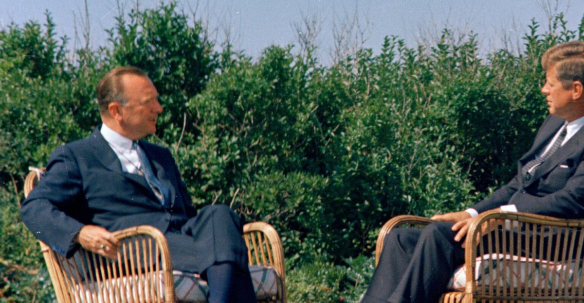 Columbia Broadcasting System (CBS) Evening News anchor, Walter Cronkite (seated at left), interviews President John F. Kennedy on the lawn outside Brambletyde house to inaugurate the first half-hour nightly news broadcast. Squaw Island, Hyannis Port, Massachusetts.