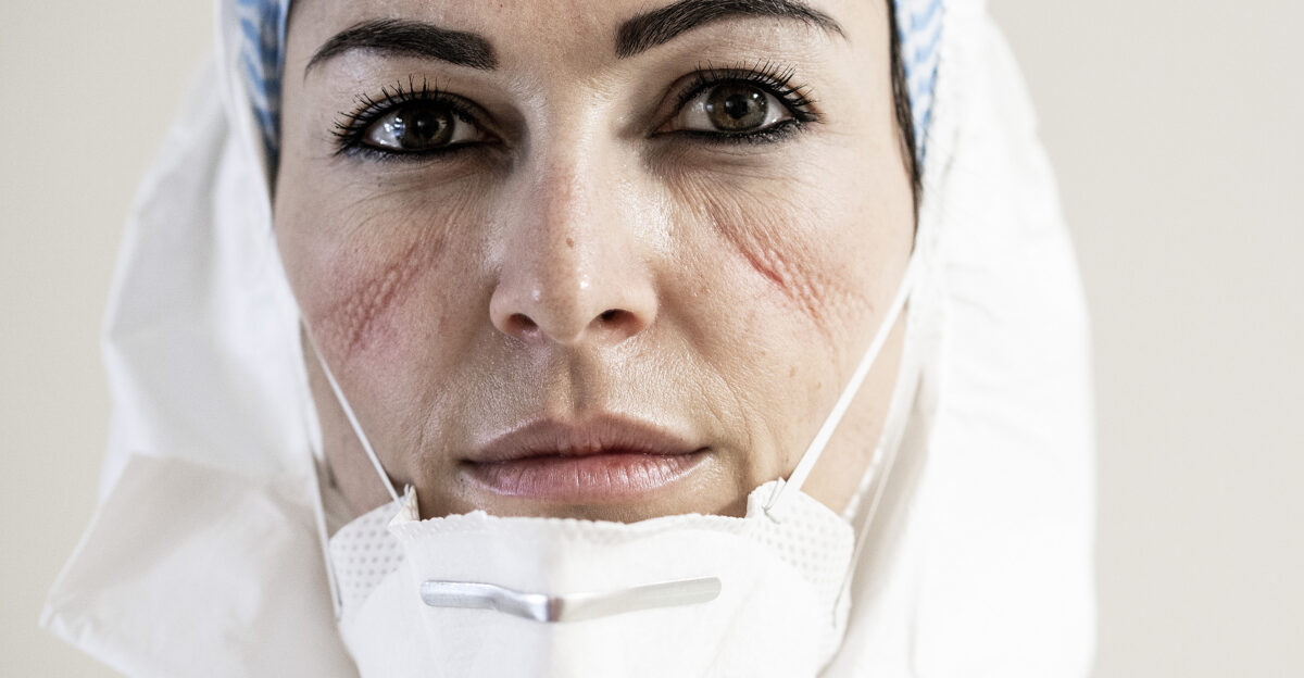 These are the doctors and nurses of the San Salvatore Hospital in Pesaro Italy the city of my birth and where I once again reside which from day one has sadly been at the top of the COVID-19 contagion and death charts I photographed them at the end of their shifts-twelve hours without a break during their fight in an unequal war In the quiet moments in front of my camera these embattled individuals are in a state of total abandon victims of an exhaustion that eats away at the body and the mind a breathlessness that renders one disoriented detached from time and space They would take off their masks caps and gloves in front of my lens remaining motionless looking for some sort of normalcy amid the hell they were living