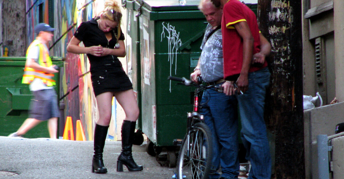 Three drug addicts seen smoking a huge amount of crack cocaine in a downtown eastside alley in Vancouver BC Canada