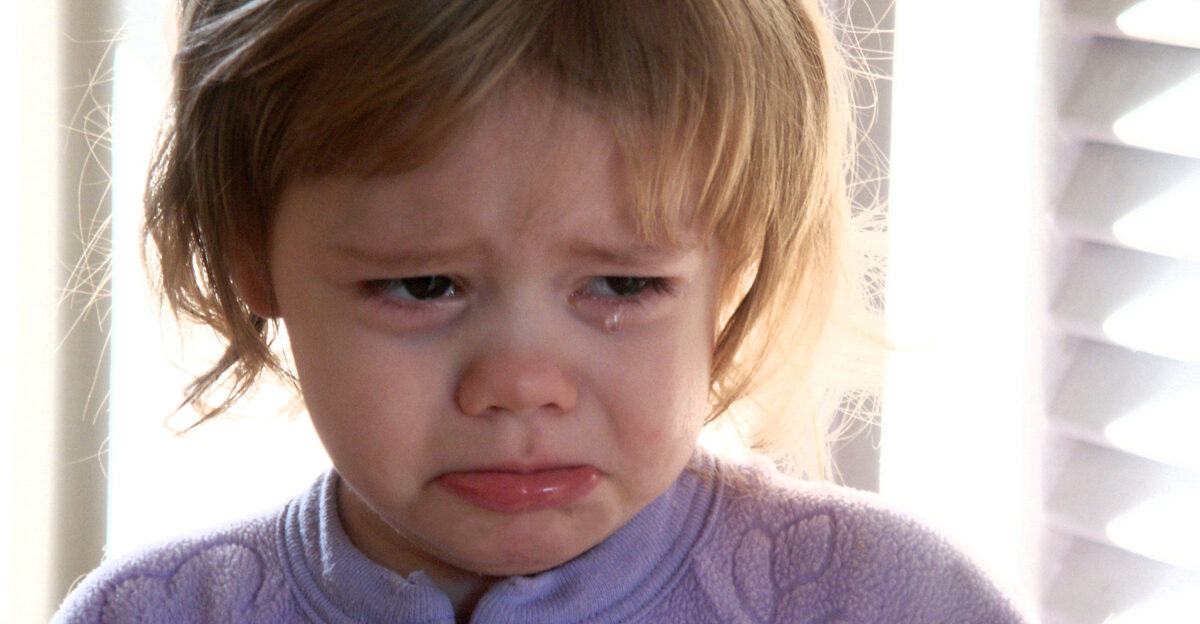 A toddler girl crying