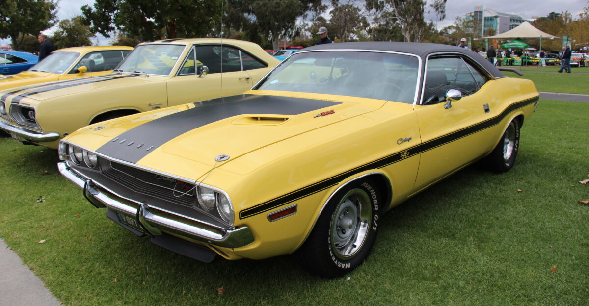 Top Banana Dodge Lemon Twist Plymouth The Challenger along with the slightly smaller Plymouth Barracuda were built on Chryslers E body pony car platform The 1970 Challenger was available in hardtop and convertible forms and available in base R T Road Track and T A Trans Am The SE Special Edition was available in conjunction with the R T Standard engines were the 145hp 225 6 cyl or 230hp 318 and 275hp 340 V8s The R T Challenger came with the 335hp 383 Magnum engine optional was the 375hp 440 Magnum 390hp 440 6 pack or 425 hp 426 Hemi It also got the rallye instrument cluster heavy duty brakes and suspension power bulge hood hood pins and 2 air intakes the shaker hood was optional The Challenger T A Trans Am was produced to qualify the Challenger for Trans Am racing It got the 290hp 340 Six-Pack engine a special flat-black fiberglass hood with huge hood scoop front and rear spoilers special side stripes side-exiting exhaust pipes upgraded suspension and larger tires This car has the V Code 440 V8 which got the 6 pack carbys optional on the RT