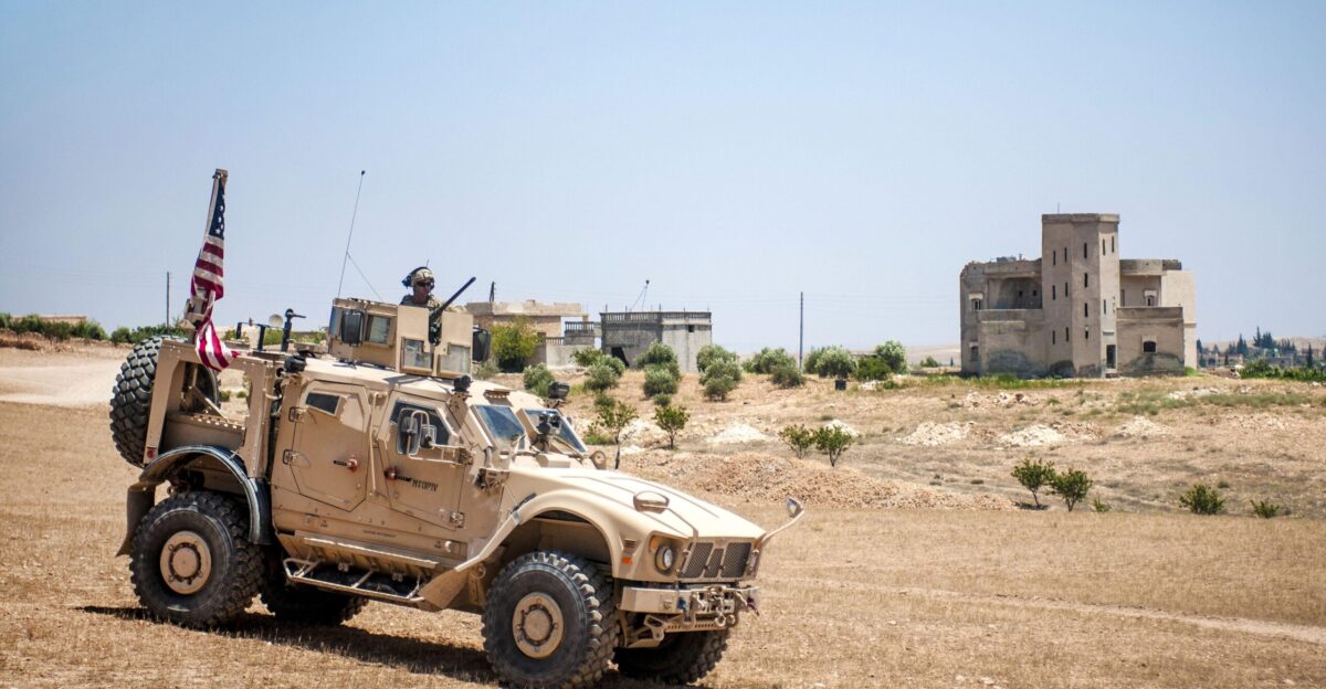 U S soldiers drive their tactical vehicle through a blockade